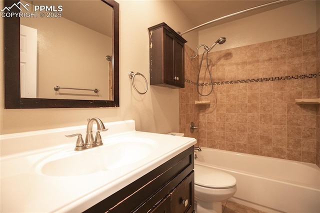 bathroom featuring toilet, vanity, and bathtub / shower combination