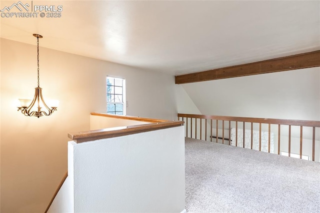 hallway featuring carpet flooring and an upstairs landing