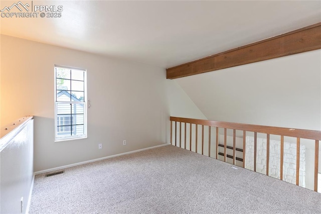 empty room featuring carpet floors and baseboards