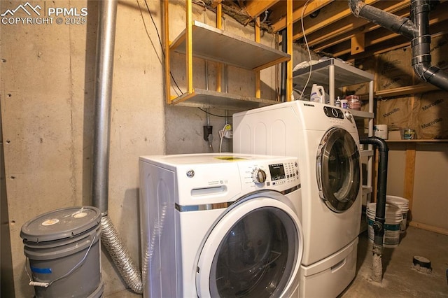 laundry area featuring washing machine and clothes dryer