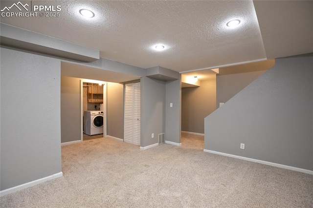 finished basement featuring washer / clothes dryer, a textured ceiling, carpet flooring, baseboards, and recessed lighting