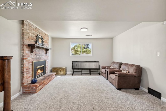 carpeted living area featuring a brick fireplace, baseboards, and visible vents