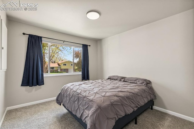 carpeted bedroom featuring baseboards