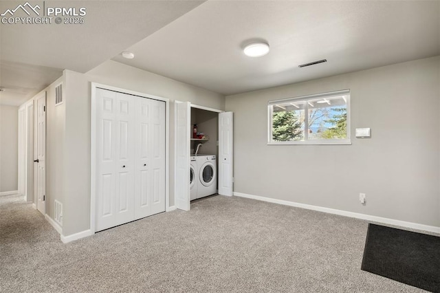 laundry room featuring washer and clothes dryer, laundry area, carpet flooring, and baseboards