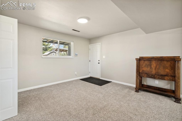 entryway with carpet, baseboards, and visible vents