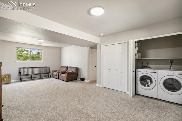 laundry room featuring washing machine and clothes dryer, baseboards, laundry area, and carpet floors