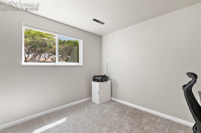 empty room with carpet and baseboards
