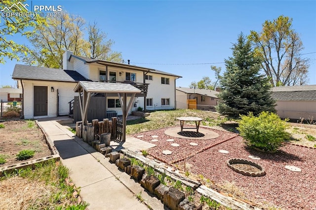 rear view of property featuring fence and a patio area