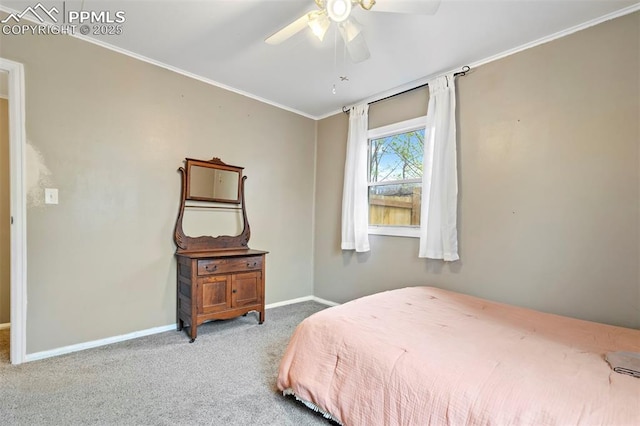 carpeted bedroom with a ceiling fan, ornamental molding, and baseboards