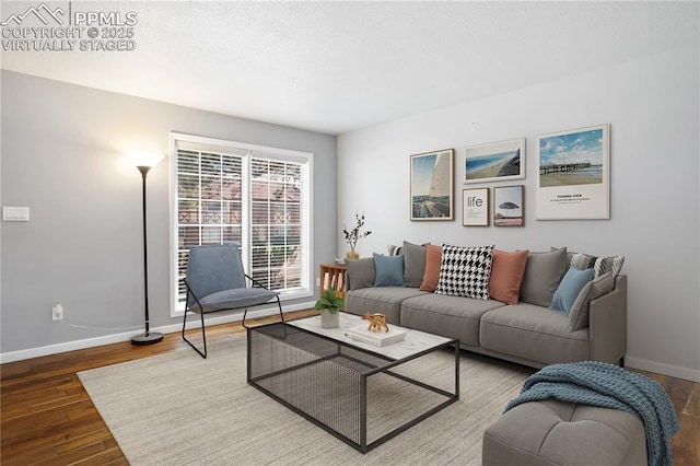 living area featuring wood finished floors and baseboards