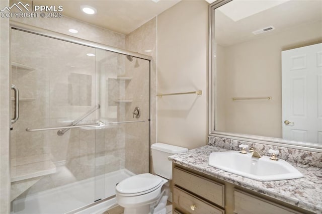 full bathroom with a stall shower, vanity, visible vents, and toilet