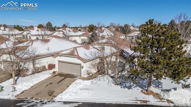 snowy aerial view featuring a residential view