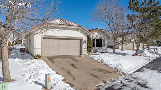 view of front facade featuring a garage, a tiled roof, concrete driveway, and stucco siding
