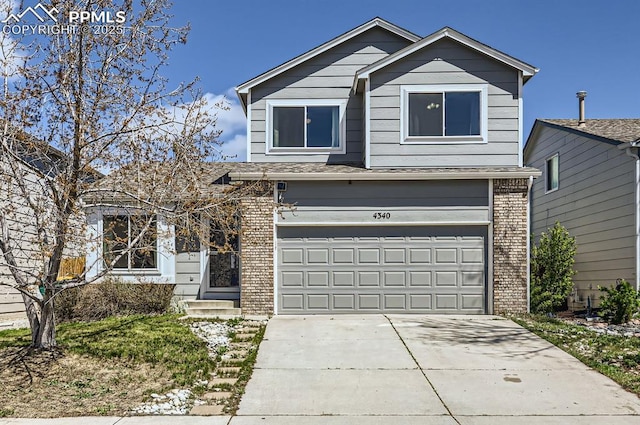 view of front facade with brick siding, an attached garage, and concrete driveway