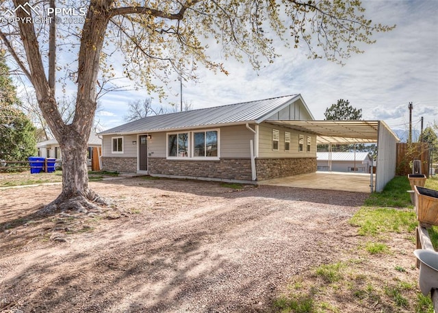 2204 Bonfoy Ave, Colorado Springs, CO 80909 - ranch-style house with a carport, dirt driveway, fence, metal roof, and a standing seam roof