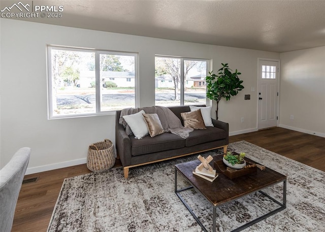 2204 Bonfoy Ave, Colorado Springs, CO 80909 - living area with visible vents, wood finished floors, and baseboards