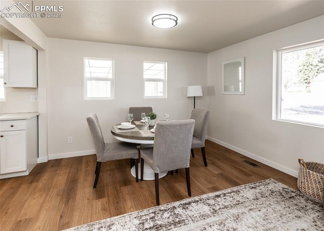 2204 Bonfoy Ave, Colorado Springs, CO 80909 - dining area featuring baseboards, wood finished floors, visible vents, and a wealth of natural light