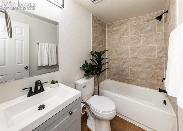 2204 Bonfoy Ave, Colorado Springs, CO 80909 - full bathroom with toilet, vanity, wood finished floors, and shower / tub combination