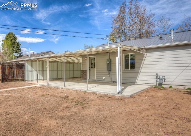 2204 Bonfoy Ave, Colorado Springs, CO 80909 - rear view of house with fence, a patio, and metal roof