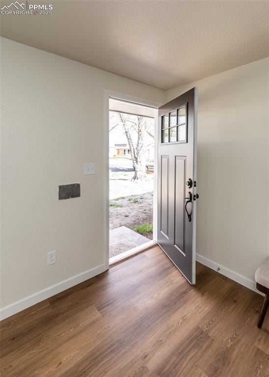 2204 Bonfoy Ave, Colorado Springs, CO 80909 - entrance foyer featuring wood finished floors, a textured ceiling, and baseboards