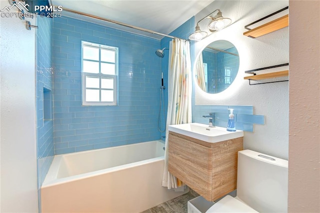 full bathroom featuring a textured wall, toilet, vanity, and shower / bathtub combination with curtain