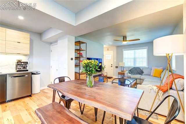 dining space with baseboards, a ceiling fan, and light wood-style flooring