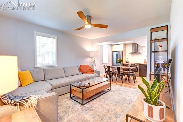 living room with ceiling fan and light wood finished floors