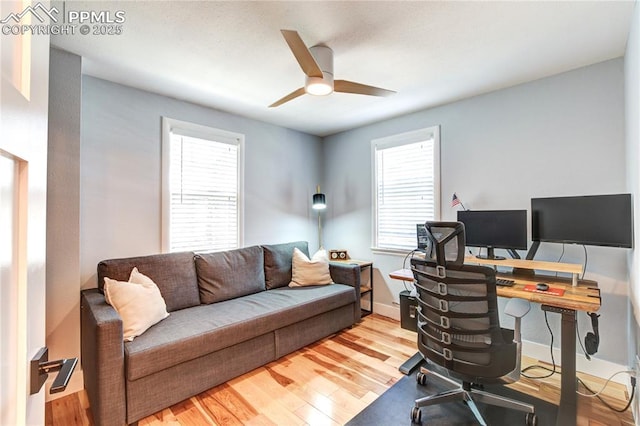 office space featuring baseboards, wood finished floors, and ceiling fan