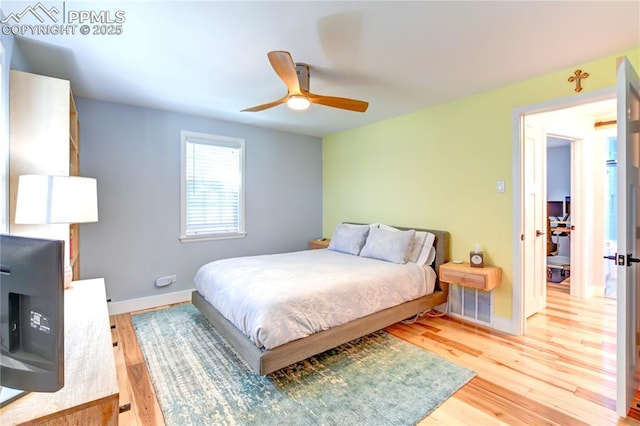 bedroom featuring light wood-type flooring, baseboards, and ceiling fan
