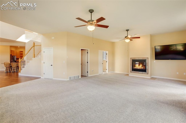 unfurnished living room with visible vents, carpet, ceiling fan, and baseboards
