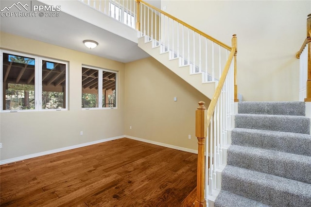 stairs featuring baseboards and wood finished floors