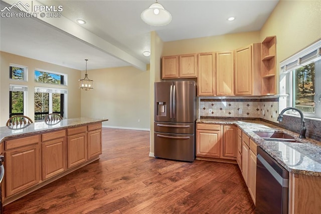kitchen featuring dark wood-style flooring, tasteful backsplash, light stone counters, a sink, and stainless steel appliances