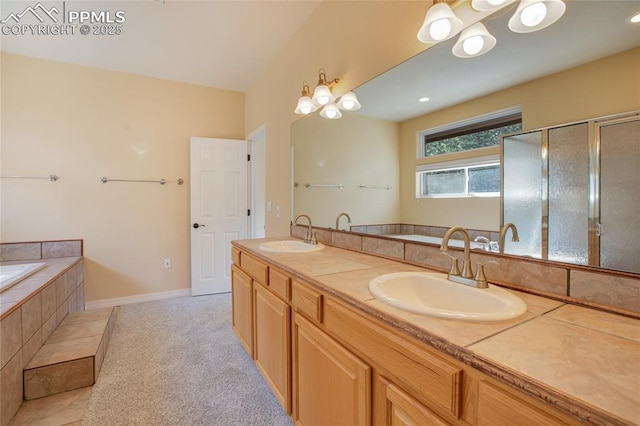 bathroom featuring a shower with shower door, double vanity, a sink, and a garden tub