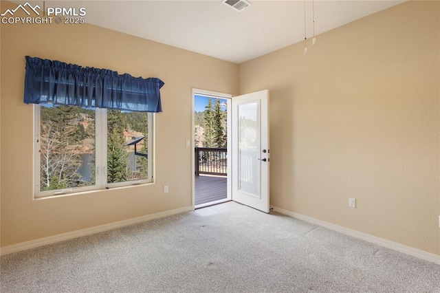 carpeted empty room with baseboards and visible vents