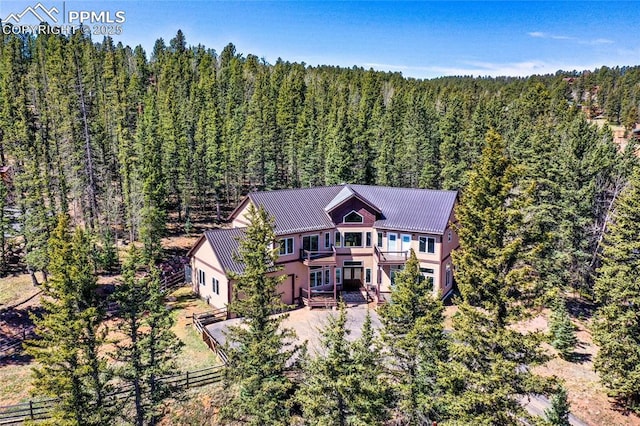 birds eye view of property with a view of trees