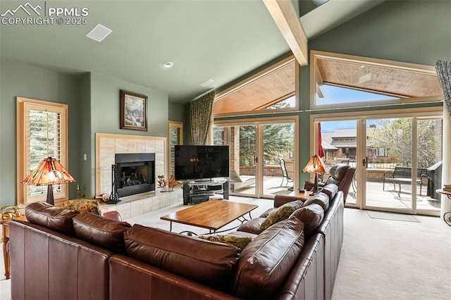 living area with lofted ceiling with beams, light colored carpet, and a fireplace