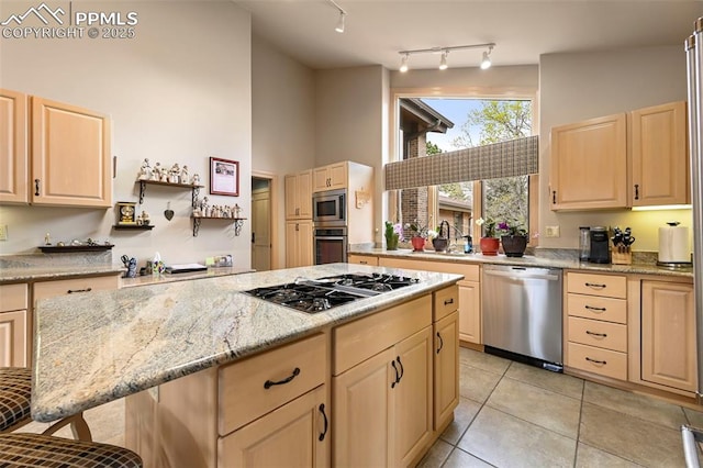 kitchen with light tile patterned flooring, stainless steel appliances, a high ceiling, and light brown cabinets