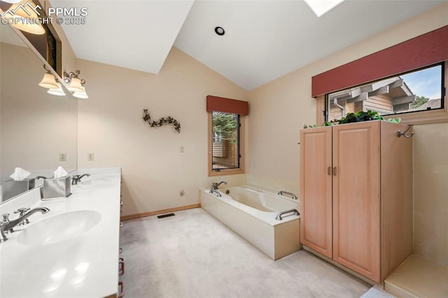 full bath with a wealth of natural light, lofted ceiling, and a sink