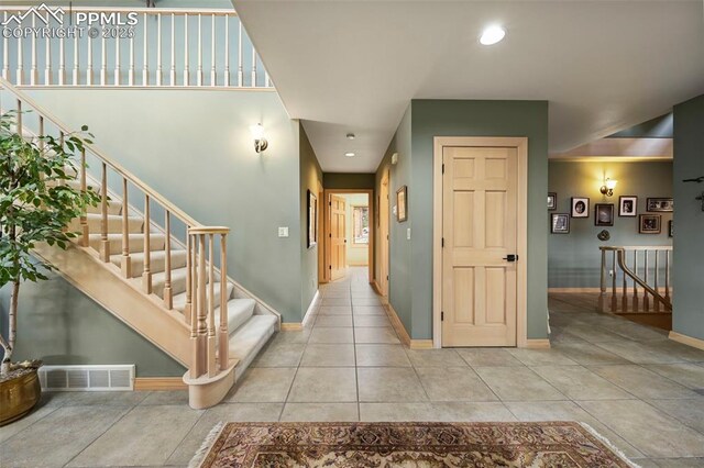 interior space featuring baseboards, visible vents, tile patterned flooring, and recessed lighting