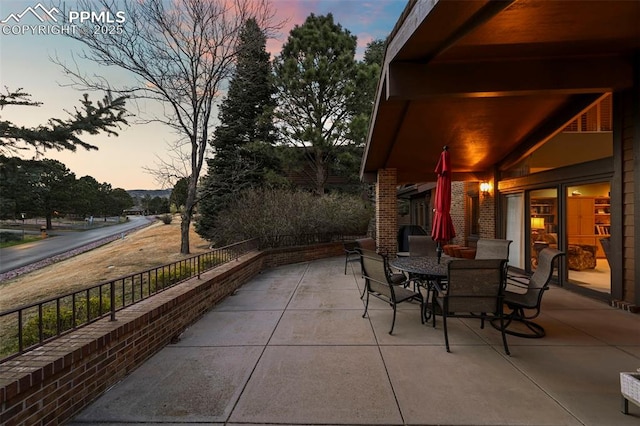 patio terrace at dusk with outdoor dining area