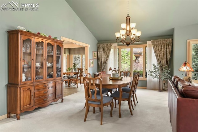 dining area featuring lofted ceiling, light colored carpet, a healthy amount of sunlight, and a notable chandelier