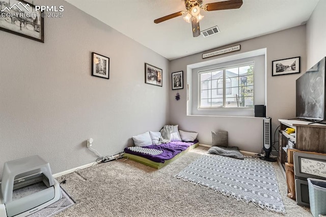 carpeted bedroom with visible vents, a ceiling fan, and baseboards