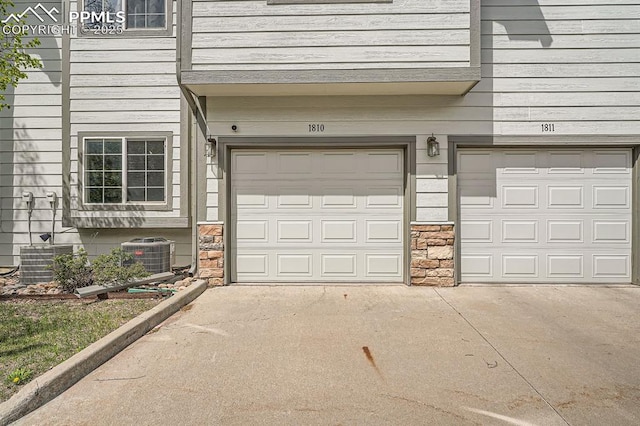 garage with central AC and driveway