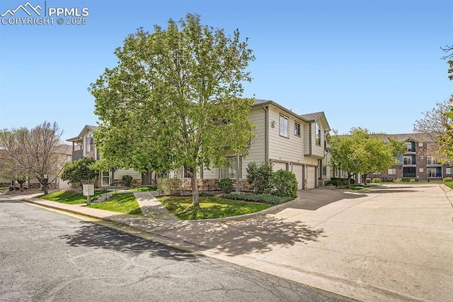 view of front of property with an attached garage, driveway, and a residential view