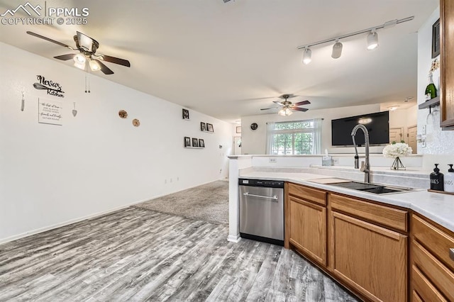 kitchen with track lighting, a sink, a peninsula, a ceiling fan, and dishwasher