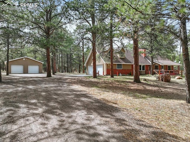 view of side of home featuring a garage and covered porch