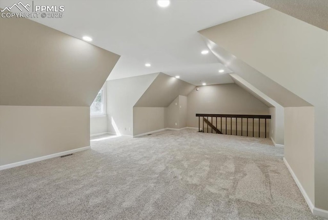 additional living space featuring recessed lighting, carpet, baseboards, and vaulted ceiling