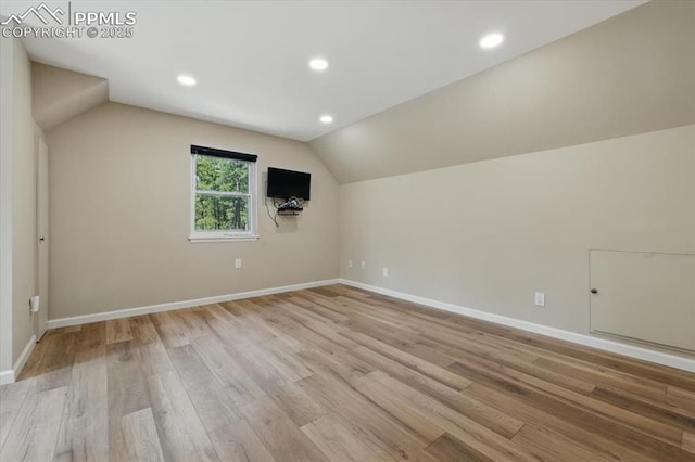 bonus room featuring light wood-style floors, baseboards, recessed lighting, and lofted ceiling