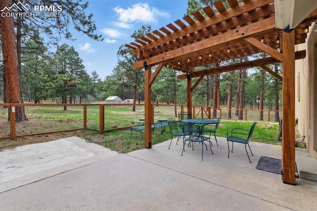 view of patio / terrace featuring fence, a pergola, and outdoor dining space