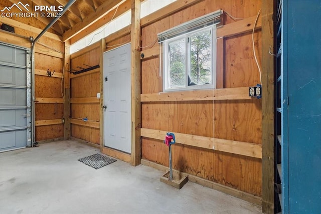 garage featuring wood walls